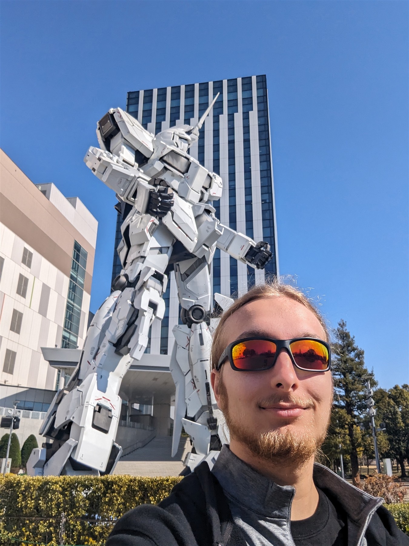 Elijah in front of the life-size Unicorn Gundam in Tokyo