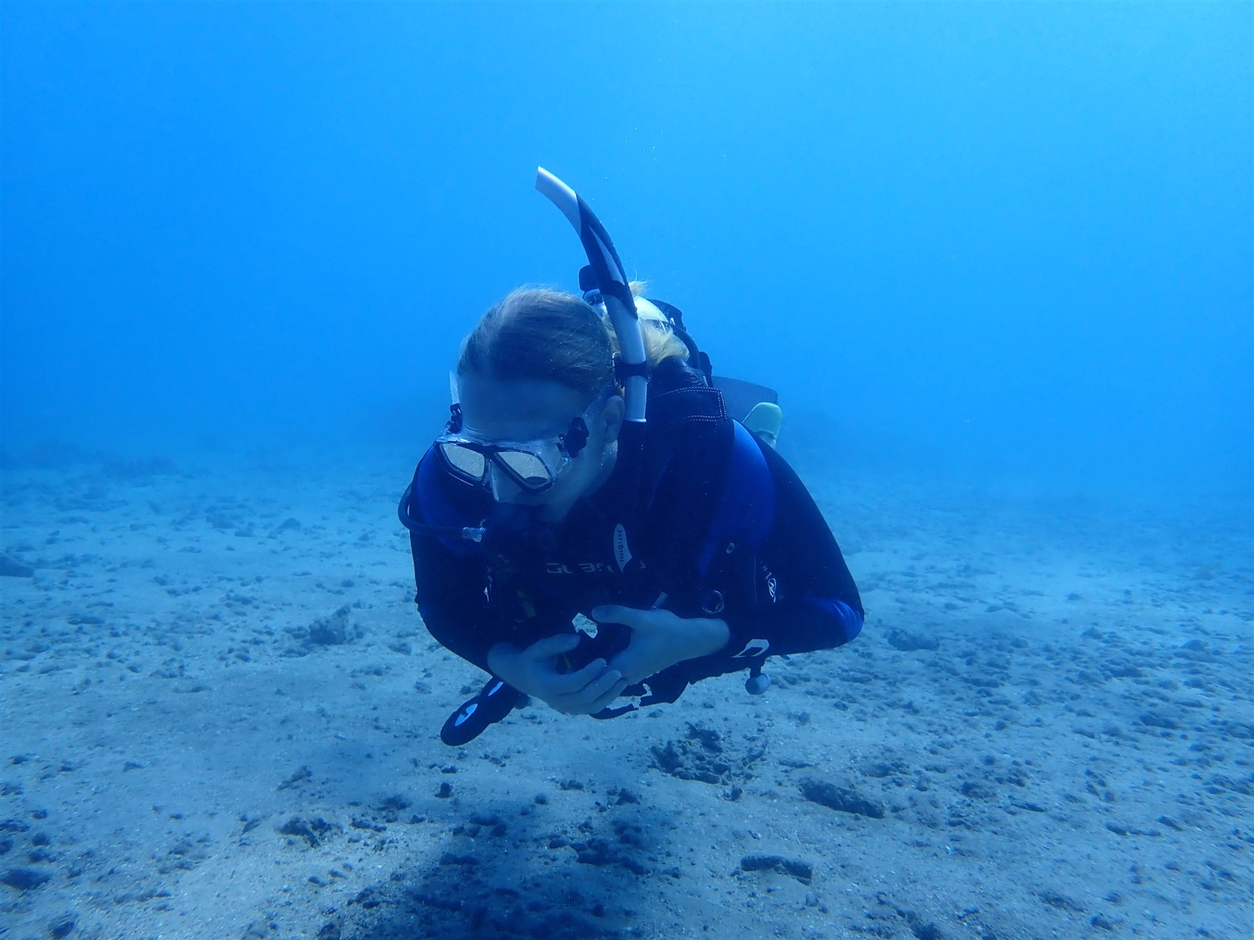 Elijah scuba diving in open blue water off Cairns
